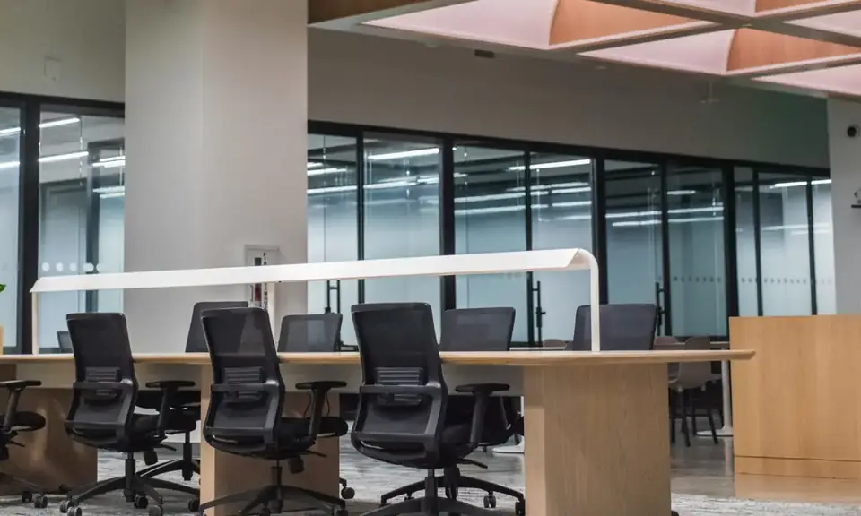 Modern open office space with glass-walled conference rooms